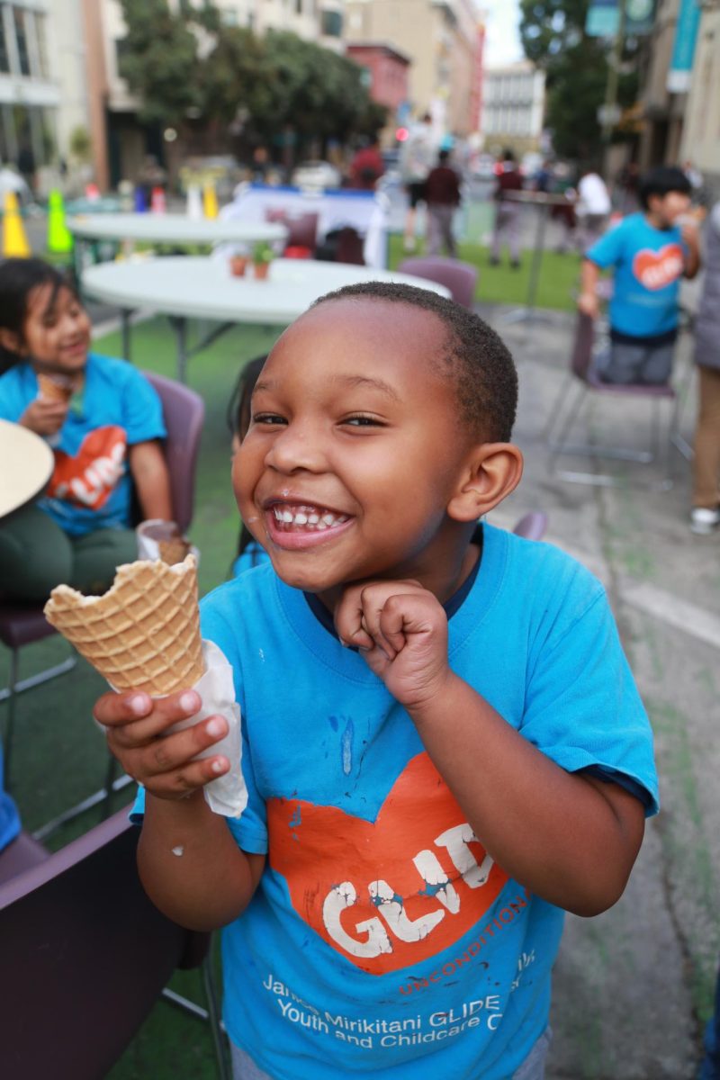 Aiden, from Glide’s FYCC beams as he enjoys his larger-than-life ice cream cone. (Hannah Clark-Nixon / Xpress Magazine)

