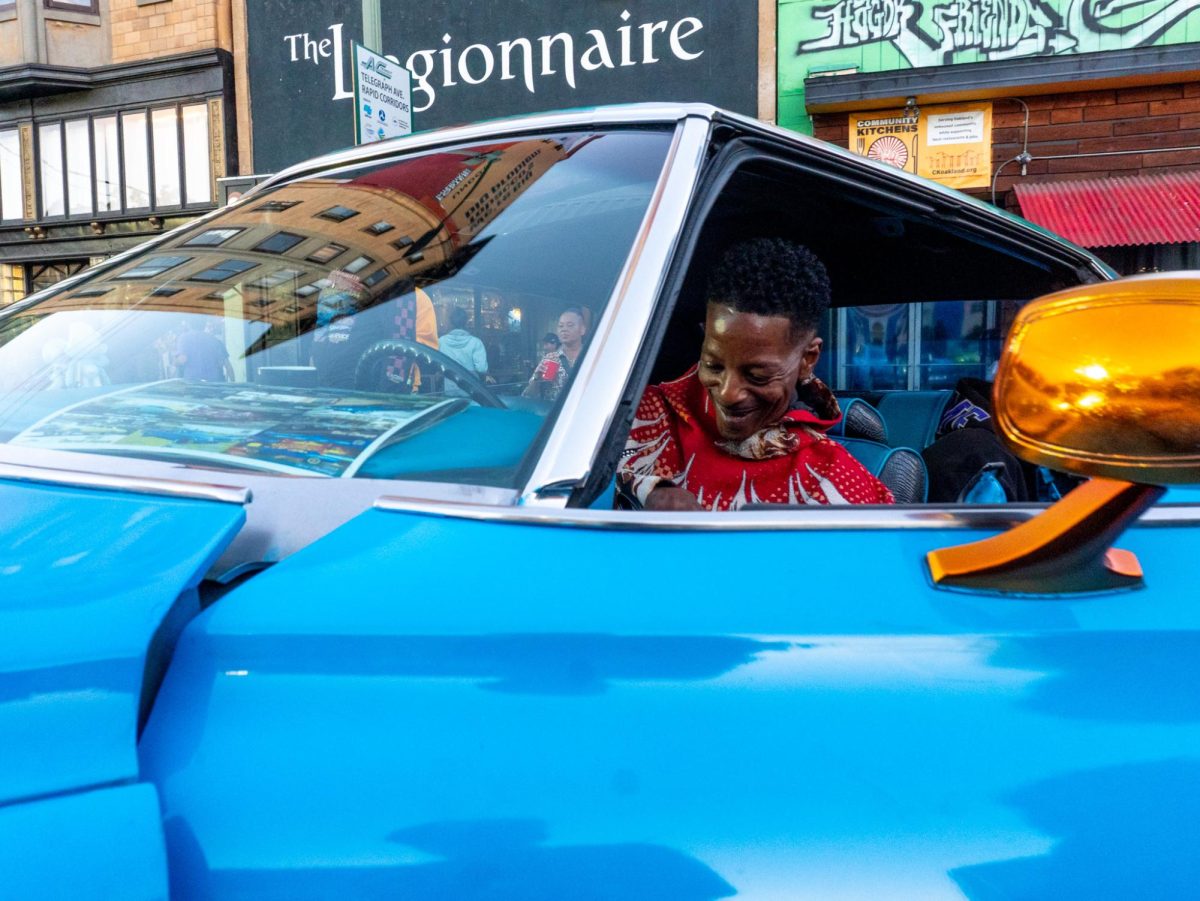 A classic Chevrolet, belonging to a Dope Era Whips Car Club member, sits on display near the beginning of October’s Oakland First Fridays street festival.  (Vanden Harris / Xpress Magazine)