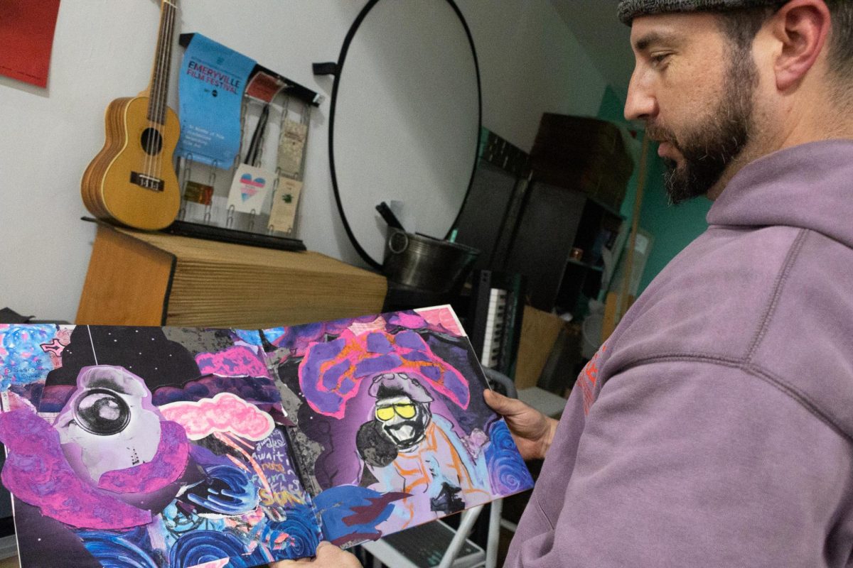 Pat Mesiti-Miller shows off a piece of art he made for a vinyl album that he pulled from the shelves of his studio in Berkeley, Ca. on Nov. 22, 2025. (Jolie Willson / Xpress Magazine)
