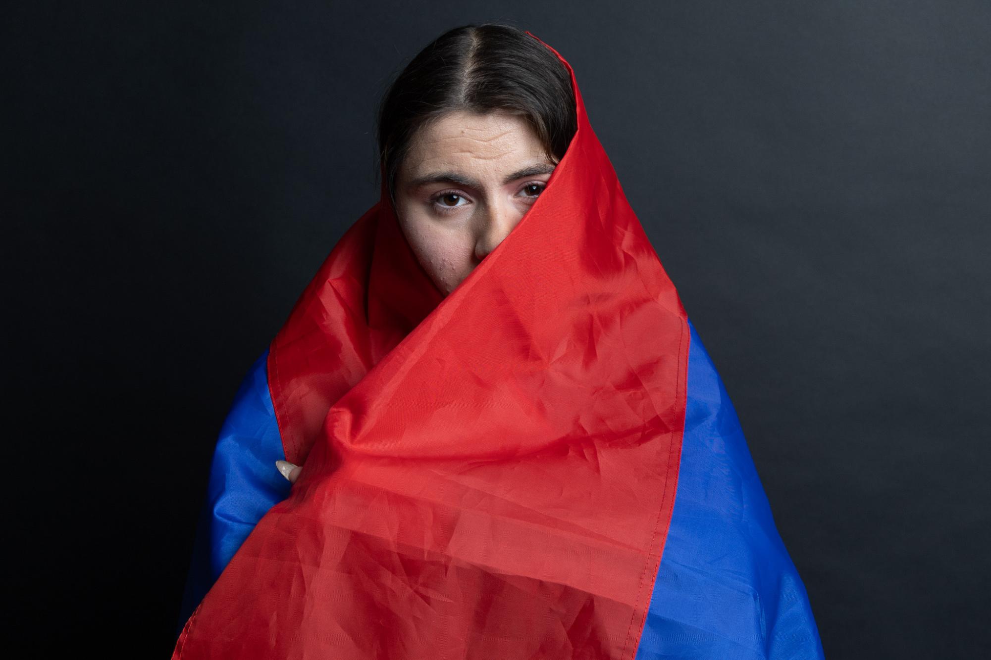 Student Zepyur Kasparian models the Armenian flag. (Jolie Willson / Xpress Magazine)