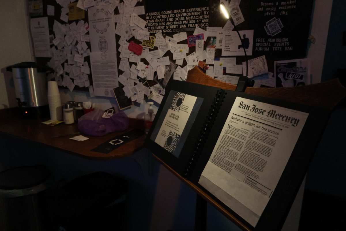 A corkboard scattered with notes of admiration and thanks left by visitors and a San Jose Mercury article from Jan. 1980 titled “Audium a Delight for the Senses,” in the lobby of the current Audium space at 1616 Bush St. (Olivia Mendez / Xpress Magazine) 