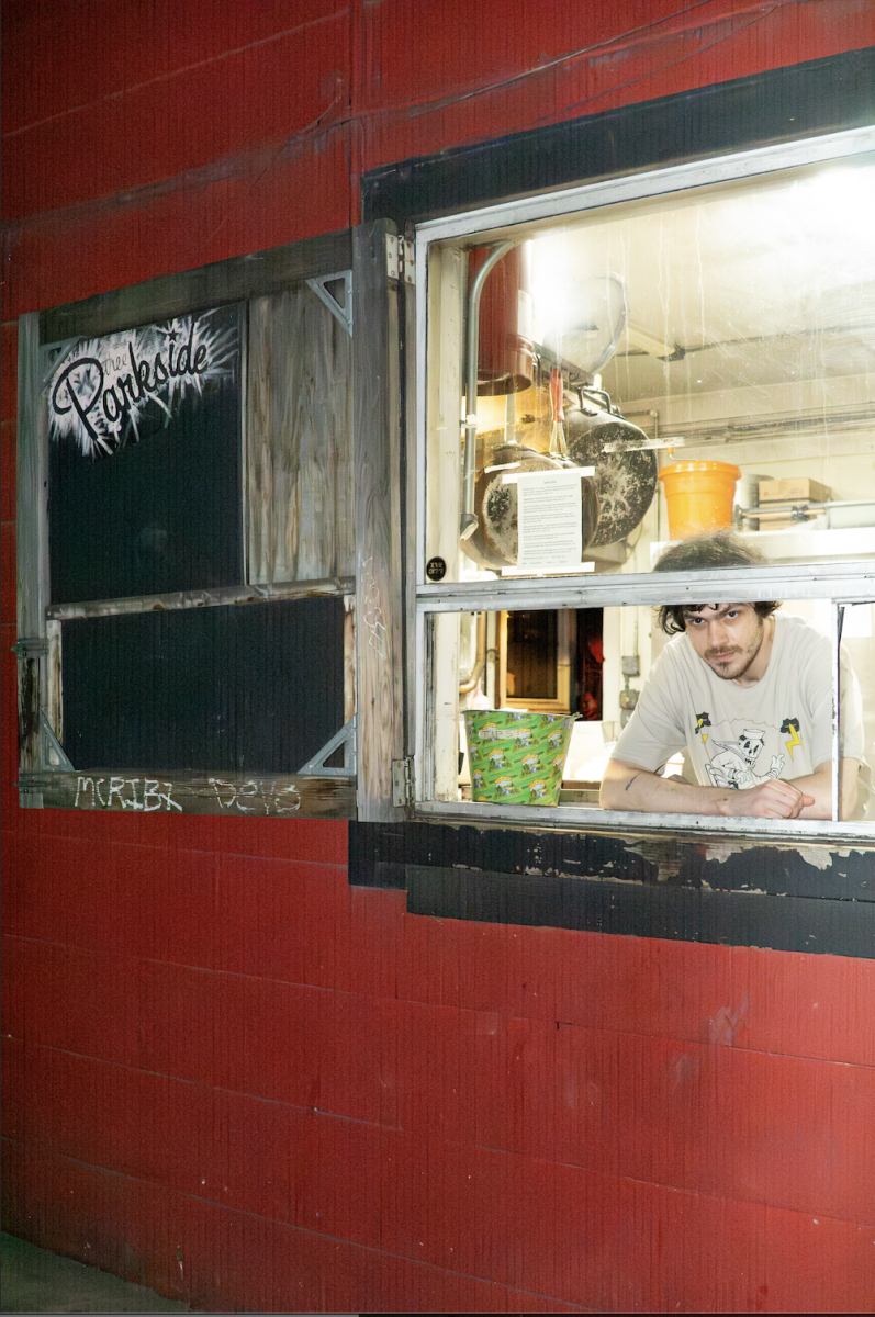 Head cook at Thee Parkside, Lydian Quintero, looks out of the to-go window at Thee Parkside. (Ryo Kojima / Xpress Magazine)