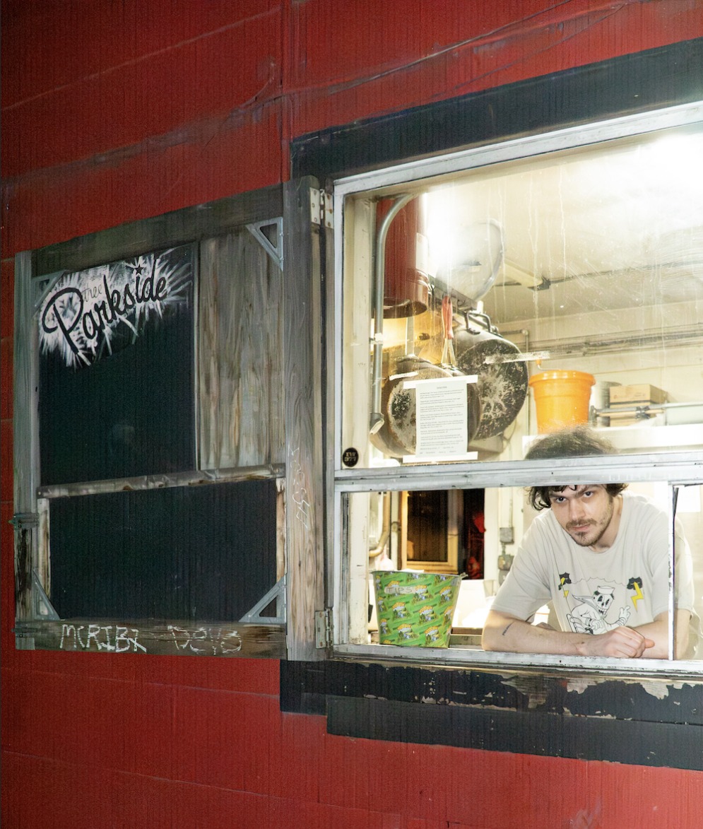 Head cook at Thee Parkside, Lydian Quintero, looks out of the to-go window at Thee Parkside. (Ryo Kojima / Xpress Magazine)