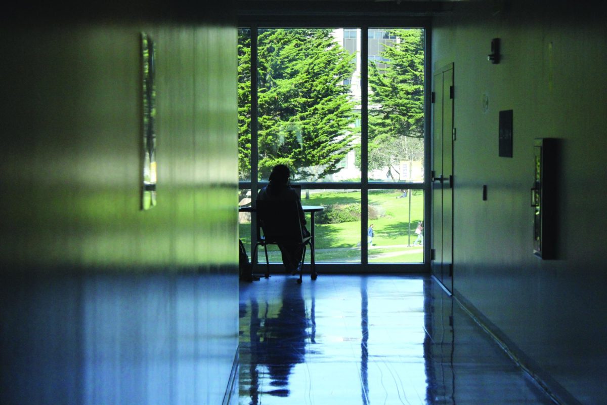 A student sits at the end of the hall in the San Francisco State University library building. (Isabella Balzarano / Xpress Magazine)