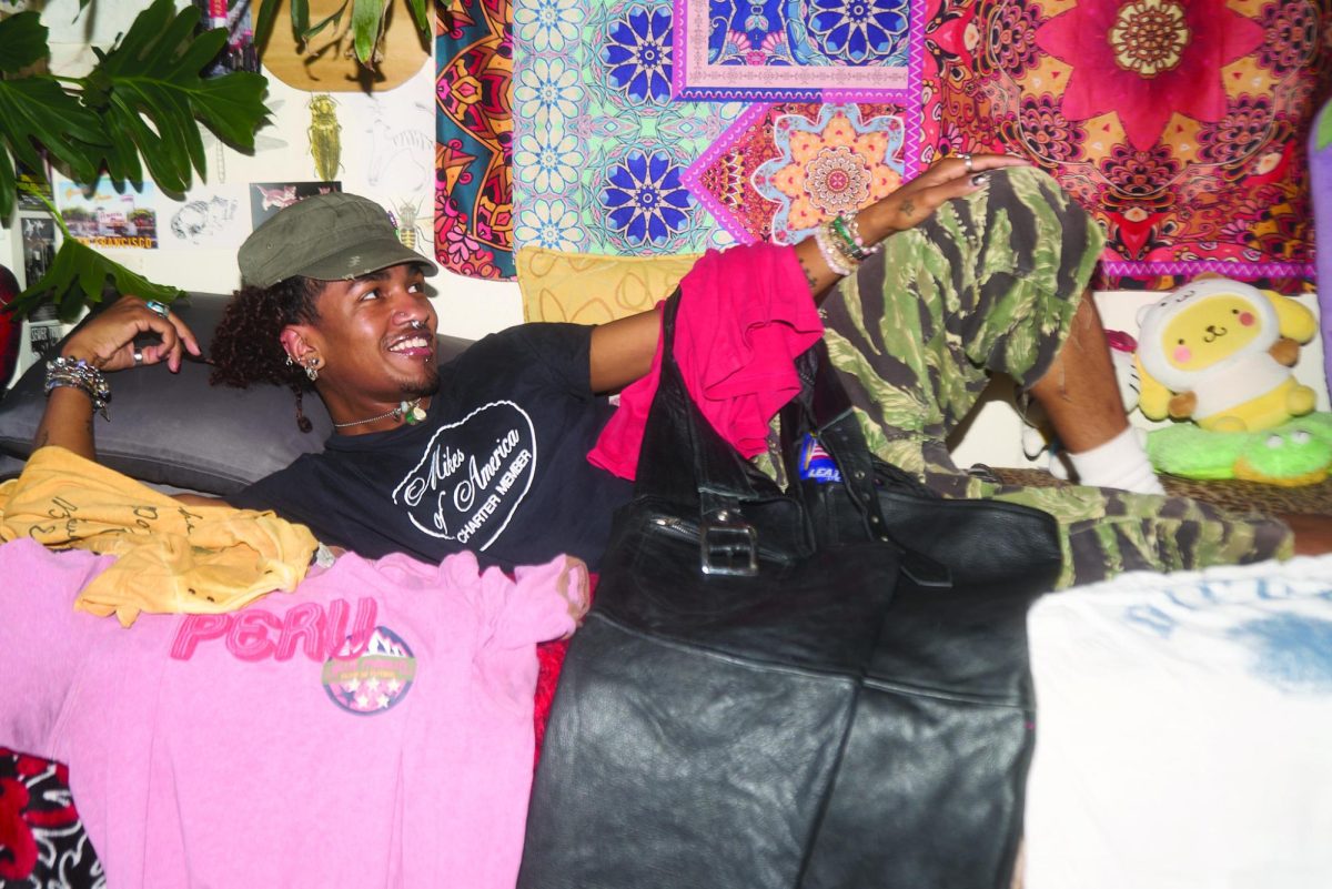 Jayden Larios laying in bed with some of their many favorite finds. (Lindsey Hoang / Xpress Magazine)