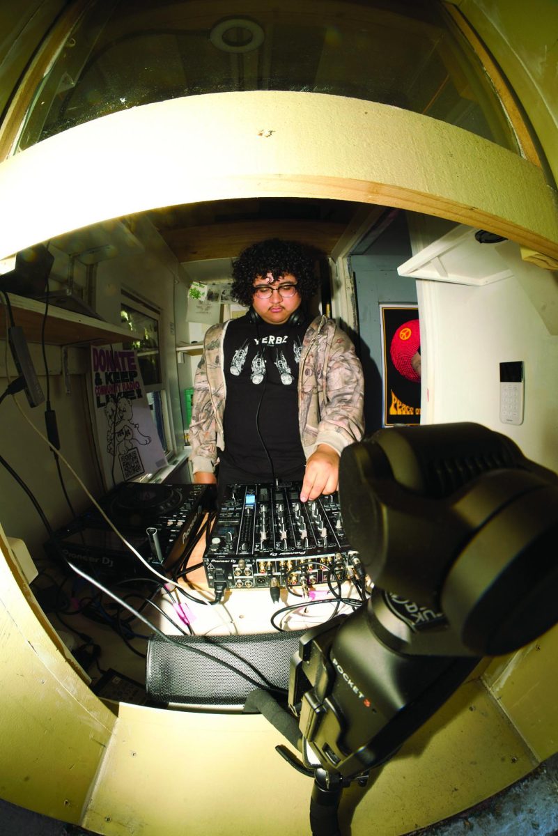 Javier Escoto performing inside Program Audio's new radio station playing their set for the people on Haight street but live online onto program audios website home page on Saturday, April 4, 2026 (Lindsey Hoang /  Xpress Magazine)