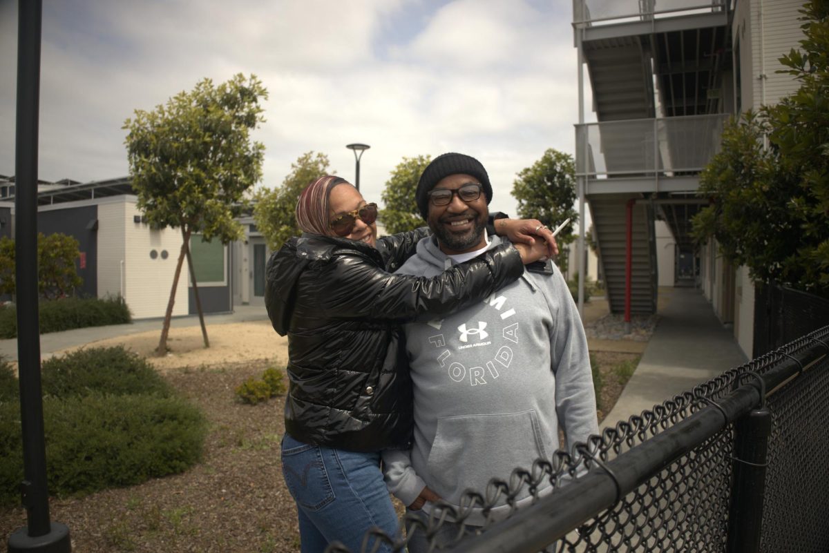 Jason Young and Krystle Vea embrace each other outside their Redwood City residence on Saturday, May 2, 2026 (Asé Mora / Xpress Magazine)